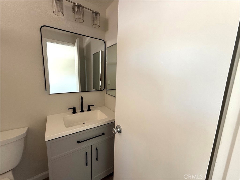 3445 Sparrow Circle Riverside, CA 92503 - Photo 22 of 41 a bathroom with a toilet sink and mirror