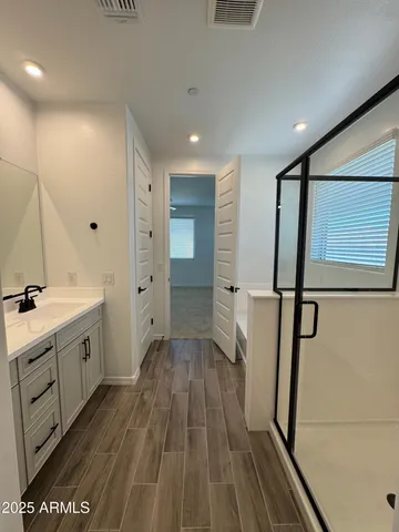 a spacious bathroom with a double vanity sink and a mirror