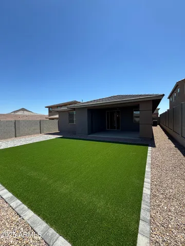a view of a house with a backyard