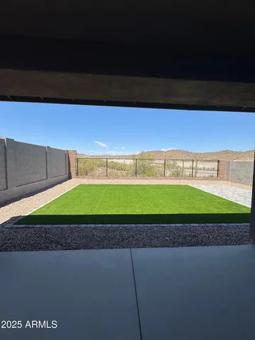 a green field with some trees in the background