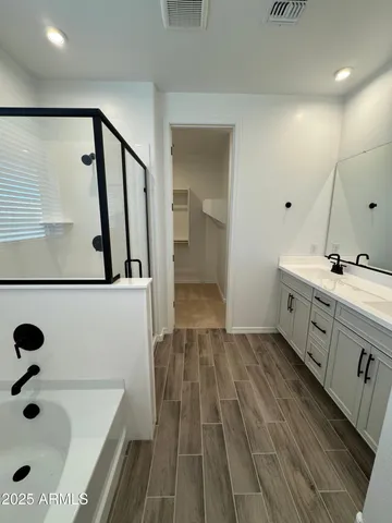 a bathroom with a double vanity sink and a mirror