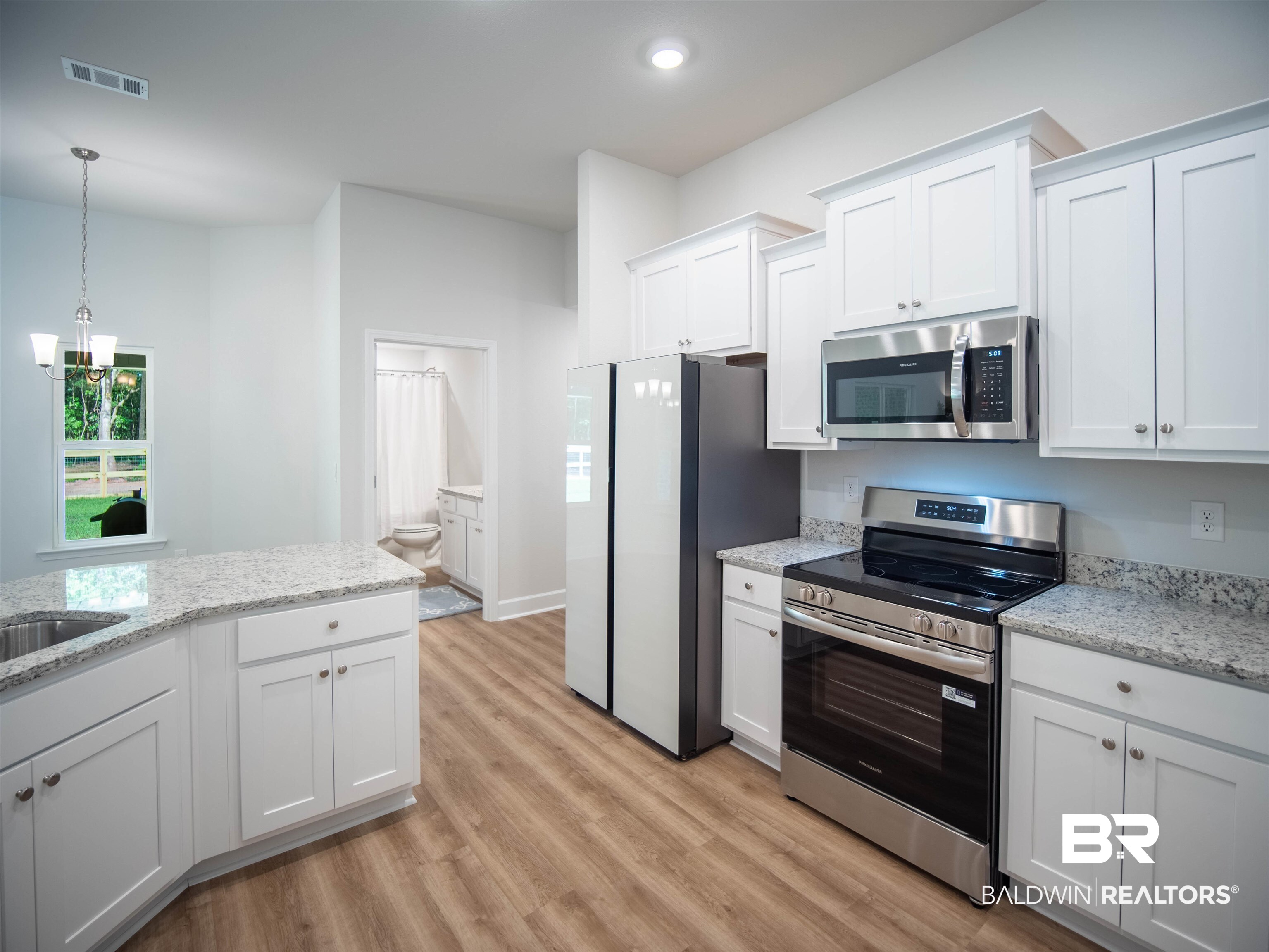 12646 Michigan Avenue Elberta, AL 36530 - Photo 13 of 47 Kitchen featuring stainless steel appliances, light wood-style flooring, white cabinets, hanging light fixtures, and recessed lighting