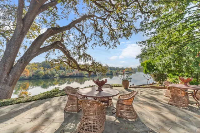 a view of a dining room with furniture a rug and wooden floor