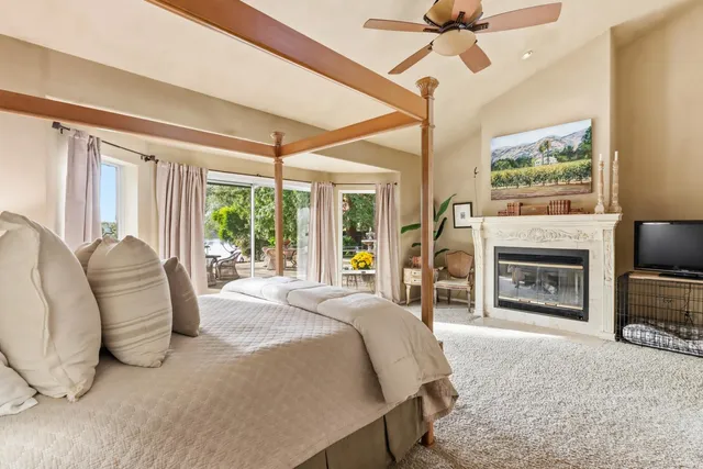 a view of a house with a yard and potted plants