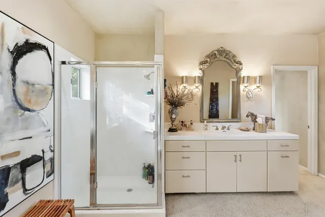 a bathroom with a sink and mirror with toilet