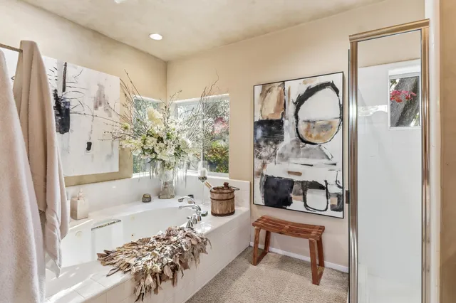 a view of a backyard with table and chairs with a large tree