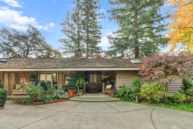 a dining hall with stainless steel appliances kitchen island granite countertop a refrigerator and a sink