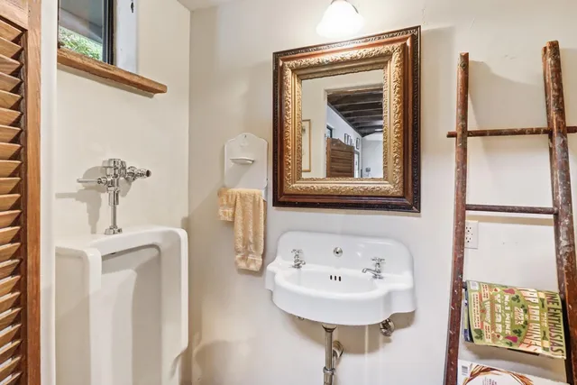 a view of a patio with couches and a fire pit and a couple of trees