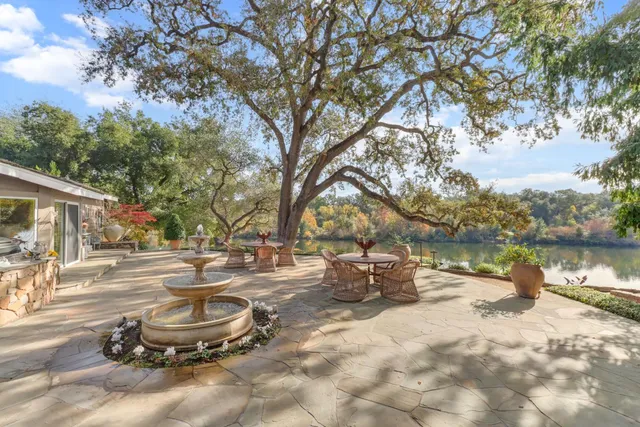 a front view of a house with swimming pool having outdoor seating