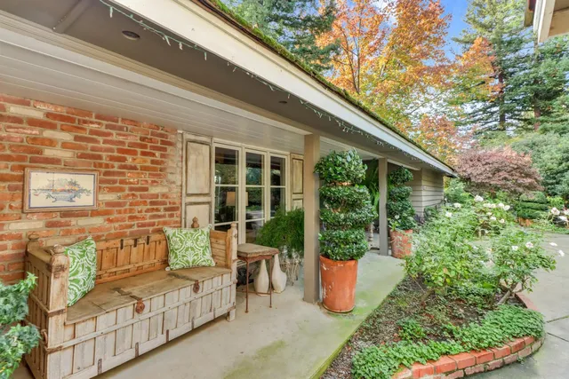 a living room with furniture large window and a fireplace