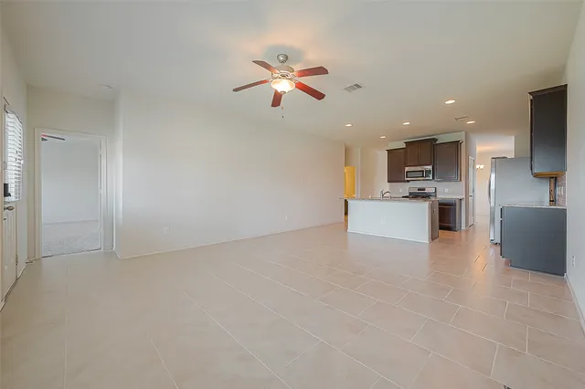 a view of a kitchen with a sink and a refrigerator
