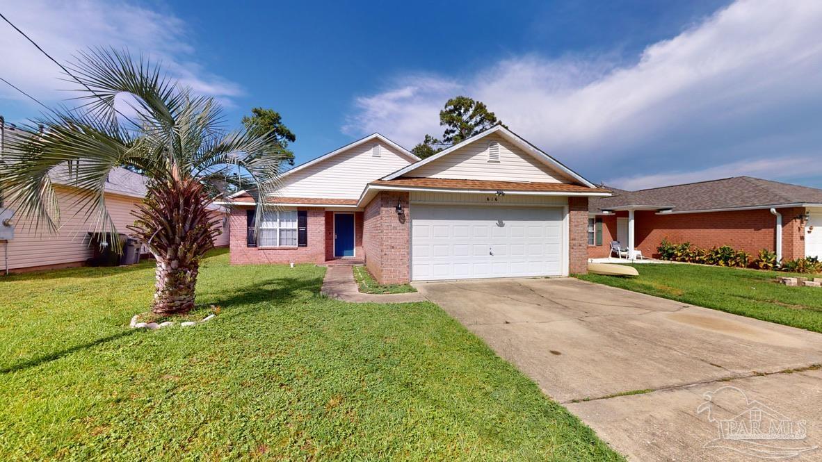a front view of a house with a yard and garage