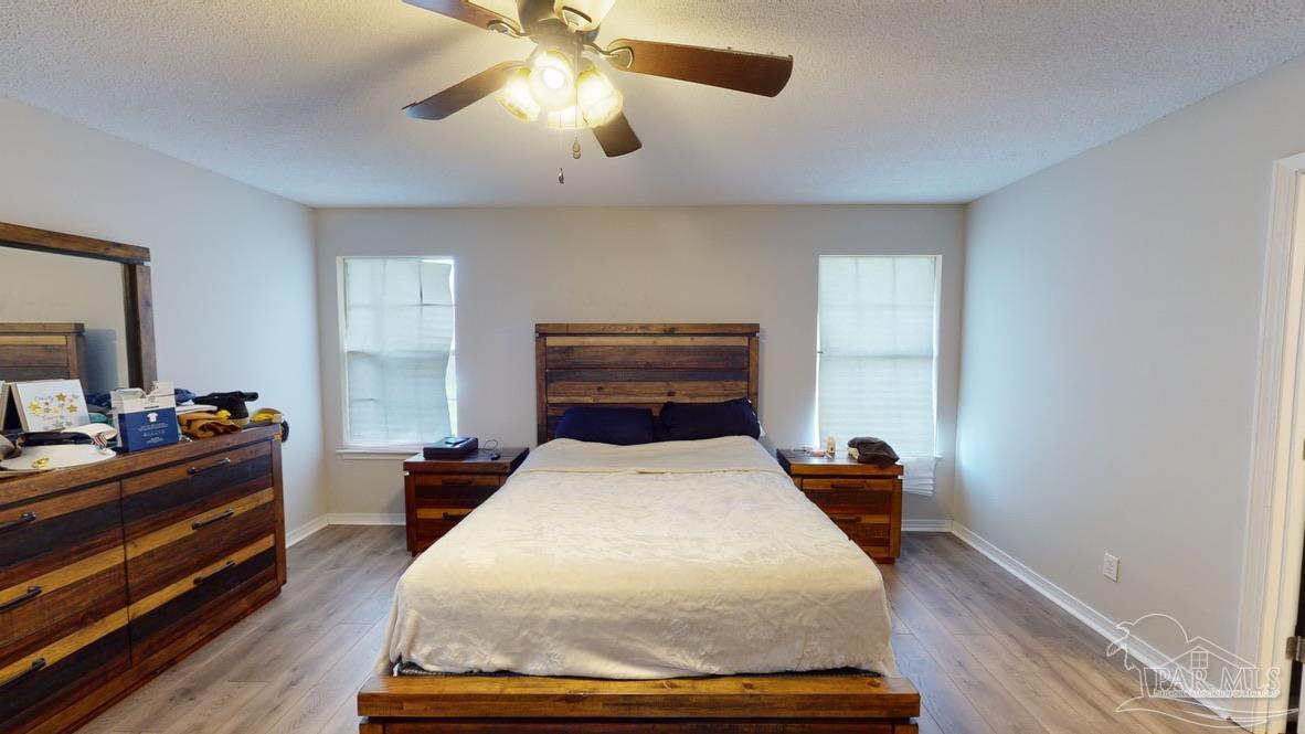 616 Reservation Avenue Pensacola, FL 32507 - Photo 17 of 29 a bed room with a bed and a chandelier