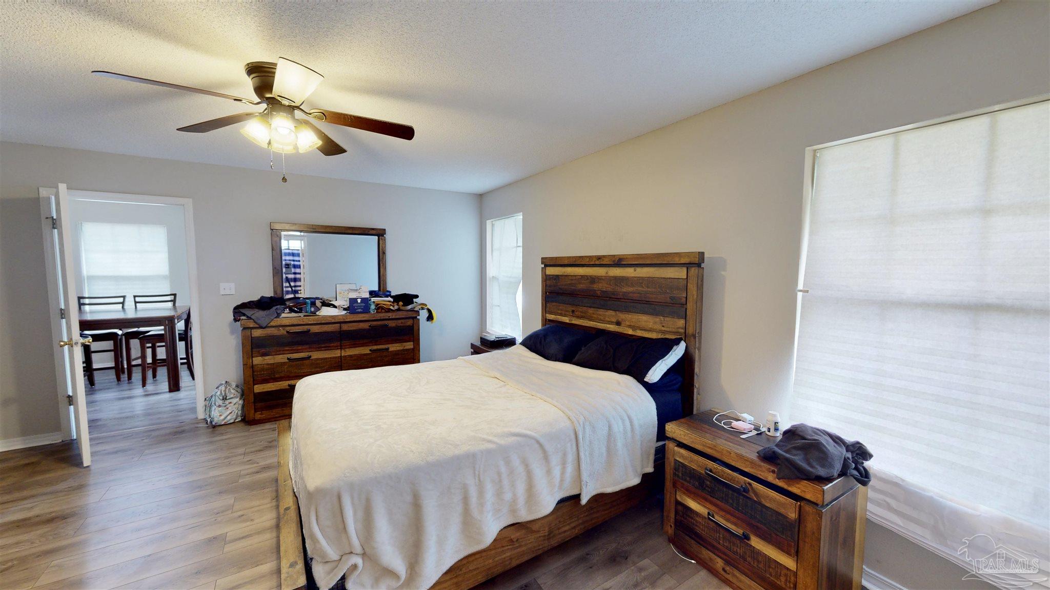 616 Reservation Avenue Pensacola, FL 32507 - Photo 19 of 29 a bedroom with a bed and wooden floor