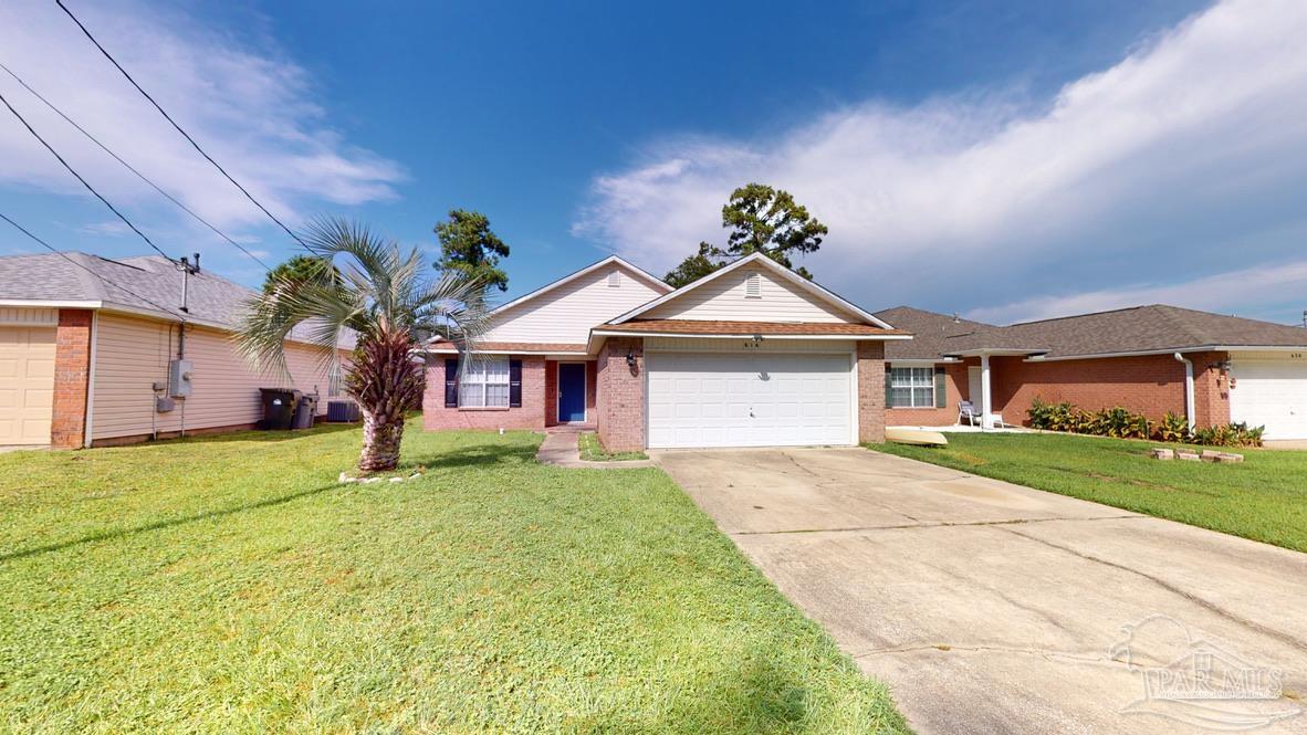 616 Reservation Avenue Pensacola, FL 32507 - Photo 2 of 29 a front view of a house with a yard and garage
