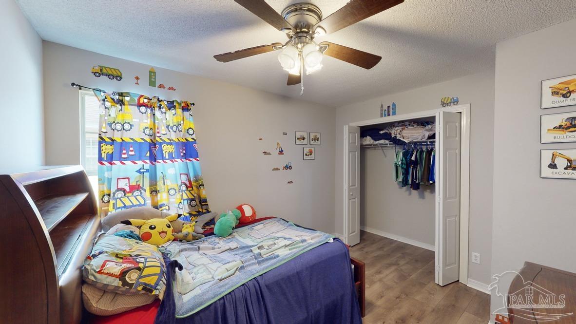 616 Reservation Avenue Pensacola, FL 32507 - Photo 22 of 29 a bedroom with furniture and a wooden floor