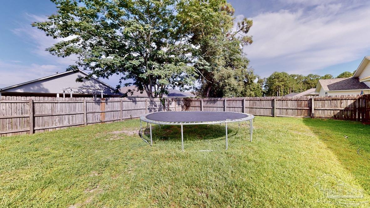 616 Reservation Avenue Pensacola, FL 32507 - Photo 29 of 29 a view of a garden with a bench