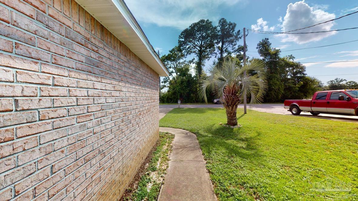 616 Reservation Avenue Pensacola, FL 32507 - Photo 4 of 29 a view of a backyard with brick wall