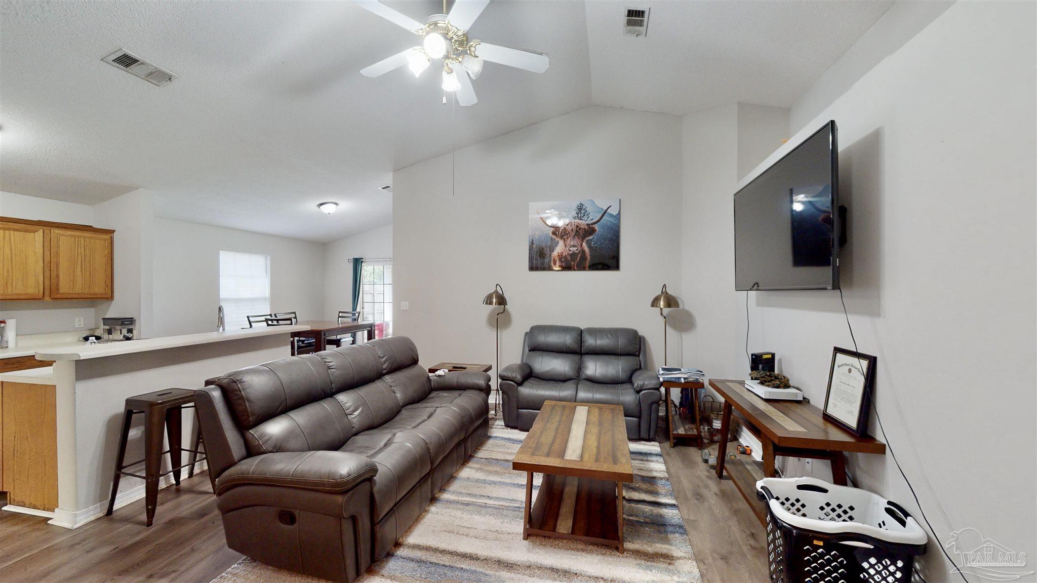 616 Reservation Avenue Pensacola, FL 32507 - Photo 7 of 29 a living room with furniture a flat screen tv and kitchen view