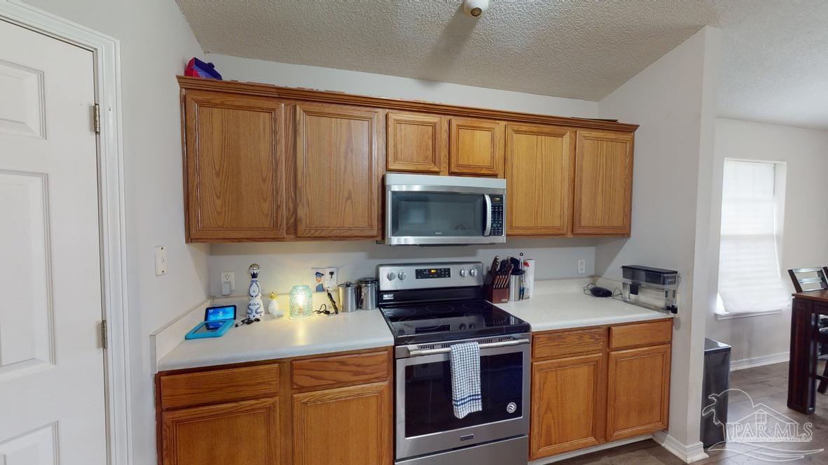 616 Reservation Avenue Pensacola, FL 32507 - Photo 10 of 29 a kitchen with stainless steel appliances granite countertop a stove sink and cabinets