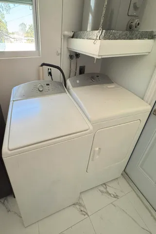 a kitchen with stainless steel appliances a refrigerator sink and microwave