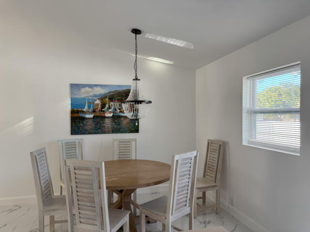 9420 Nickels Boulevard Boynton Beach, FL 33436 - Photo 28 of 57 a view of a dining room with furniture