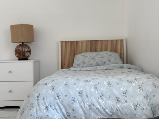 9420 Nickels Boulevard Boynton Beach, FL 33436 - Photo 35 of 57 a bedroom with a bed and a lamp on dresser