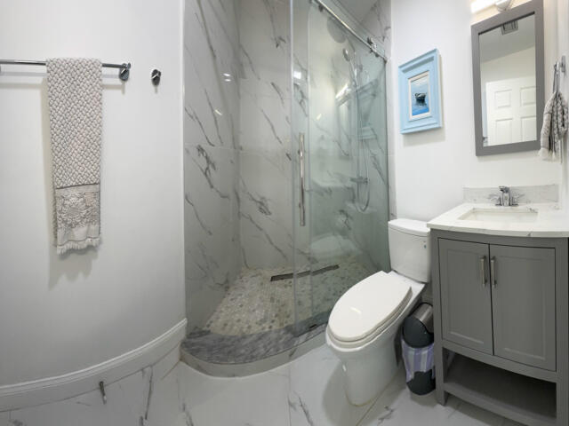 9420 Nickels Boulevard Boynton Beach, FL 33436 - Photo 39 of 57 a white toilet sitting next to a bathroom sink