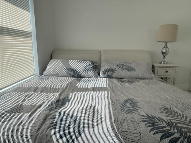 9420 Nickels Boulevard Boynton Beach, FL 33436 - Photo 42 of 57 a bedroom with a large bed and a lamp on dresser