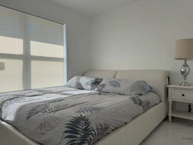 a bathroom with a granite countertop shower and a mirror