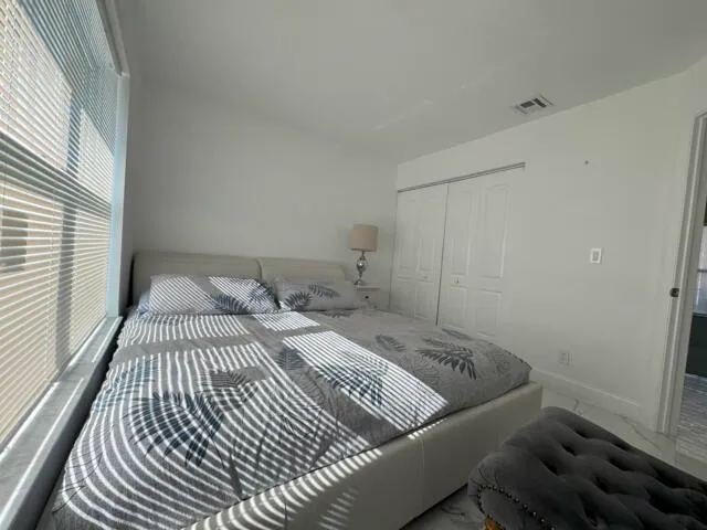 a bedroom with a bed and a television