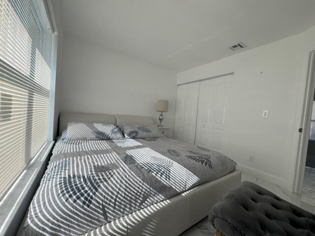 9420 Nickels Boulevard Boynton Beach, FL 33436 - Photo 44 of 57 a bedroom with a bed and wooden floor