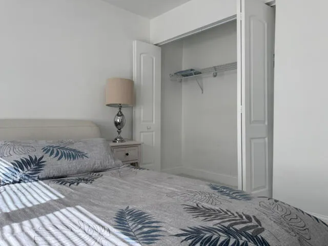 a bedroom with bed and a couch