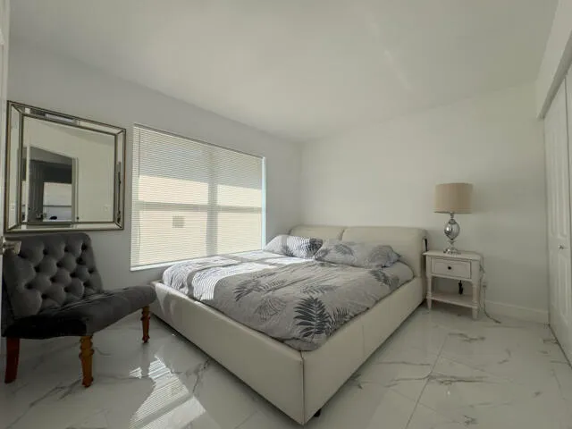 a large bed sitting in a bedroom and painting on the wall