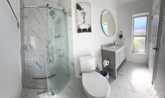 9420 Nickels Boulevard Boynton Beach, FL 33436 - Photo 48 of 57 a bathroom with a toilet a sink and a mirror