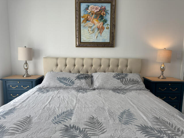 9420 Nickels Boulevard Boynton Beach, FL 33436 - Photo 53 of 57 a large bed sitting in a bedroom and painting on the wall