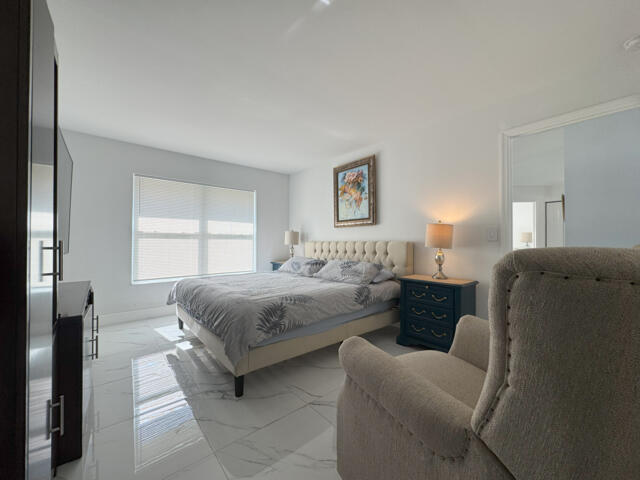 9420 Nickels Boulevard Boynton Beach, FL 33436 - Photo 56 of 57 a bedroom with bed and window