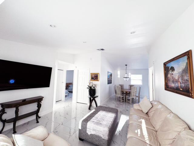 9420 Nickels Boulevard Boynton Beach, FL 33436 - Photo 57 of 57 a living room with furniture and a flat screen tv
