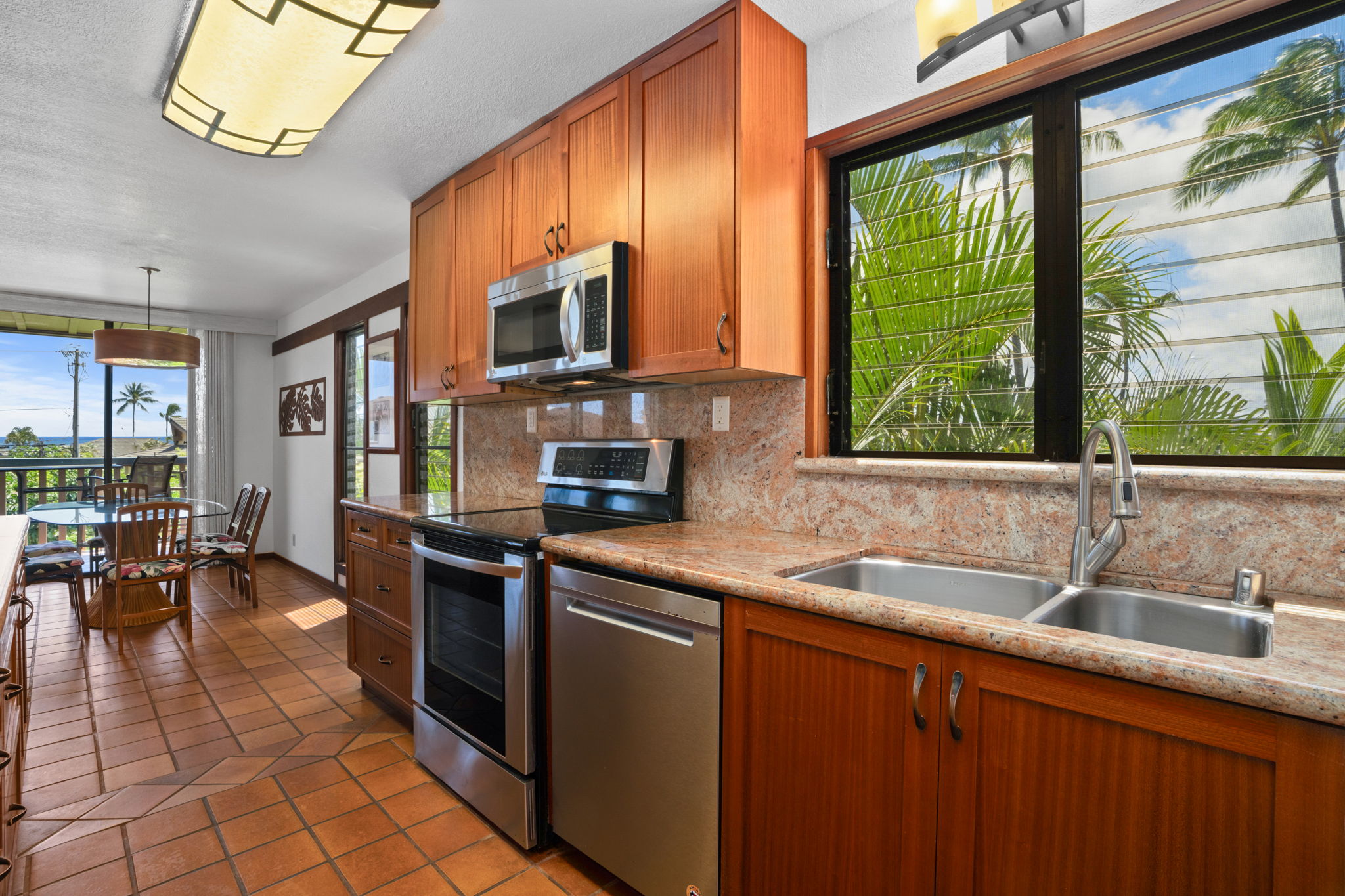 1870 Hoone Road, Unit 511 Koloa, HI 96756 - Photo 11 of 26 a kitchen with stainless steel appliances a sink window and cabinets