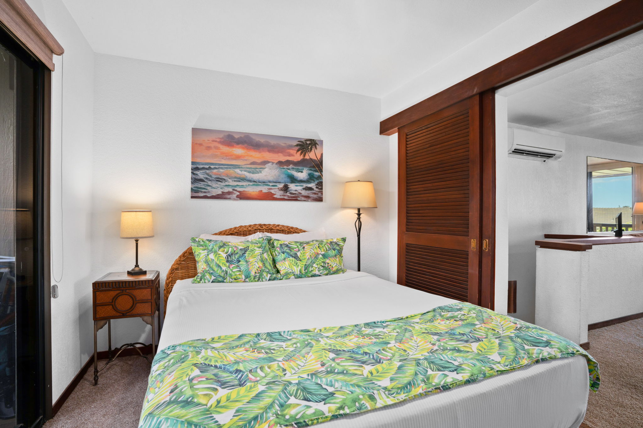 1870 Hoone Road, Unit 511 Koloa, HI 96756 - Photo 15 of 26 a bedroom with a bed and a painting on the wall