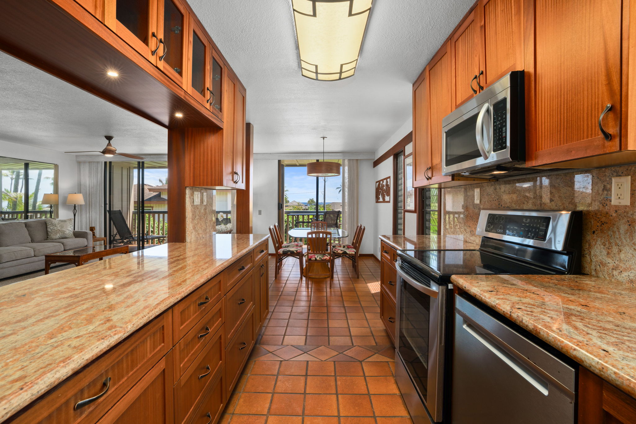 1870 Hoone Road, Unit 511 Koloa, HI 96756 - Photo 9 of 26 a large kitchen with stainless steel appliances granite countertop a lot of counter space and a wooden floors