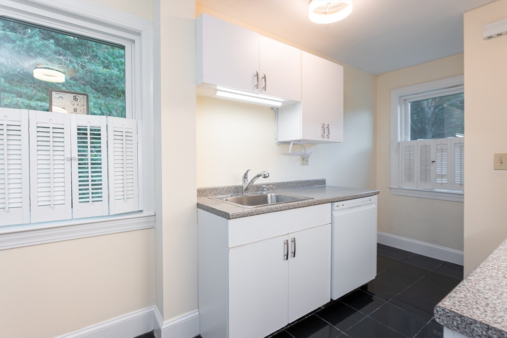 187 Acton Road Chelmsford, MA 01824 - Photo 7 of 42 a kitchen with a sink cabinets appliances and a window