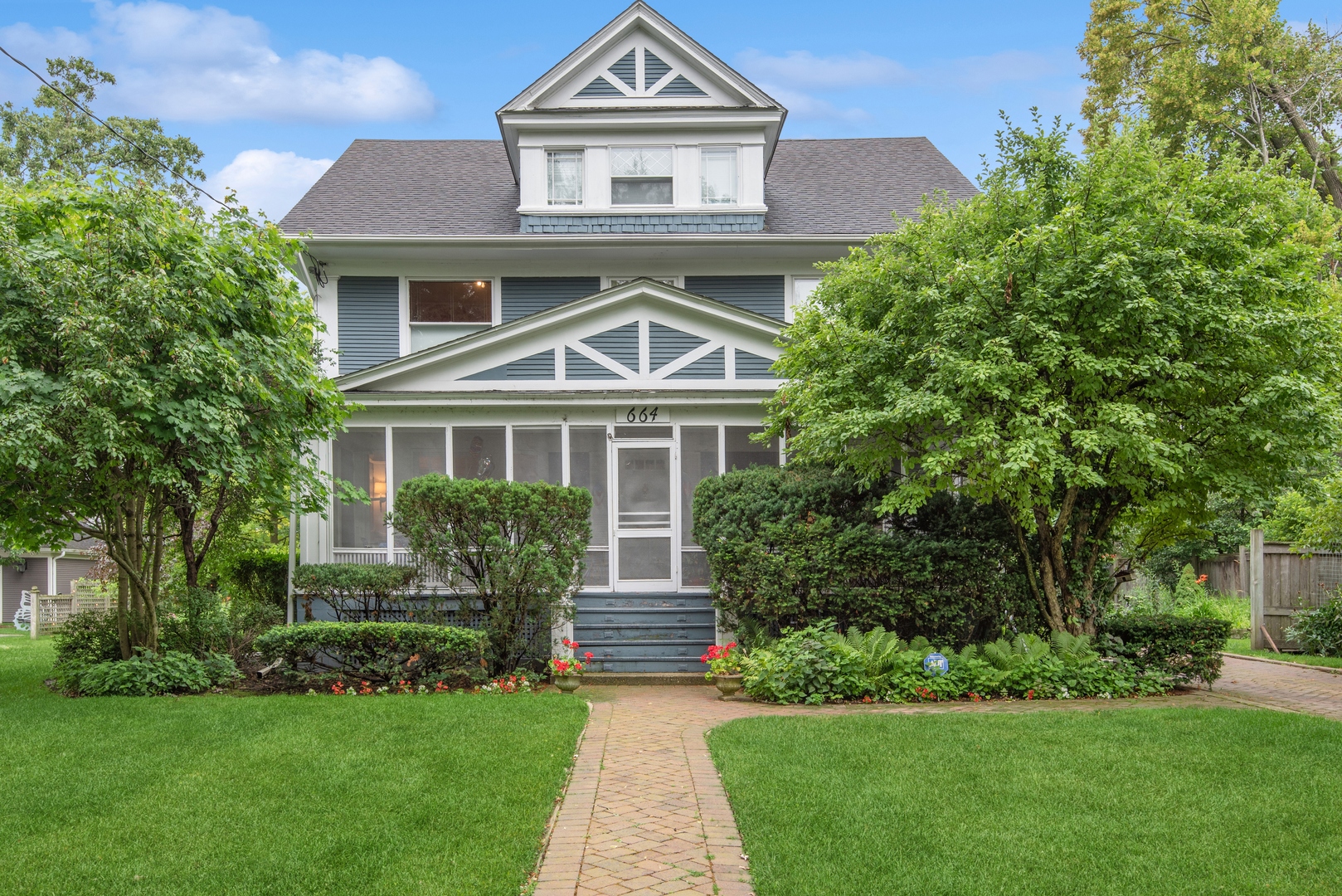 664 Lincoln Avenue Winnetka, IL 60093 - Photo 1 of 26 a front view of a house with a yard