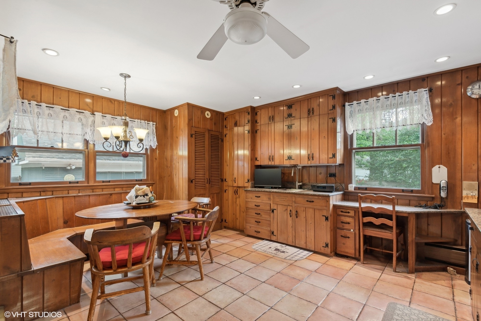 664 Lincoln Avenue Winnetka, IL 60093 - Photo 12 of 26 a kitchen with stainless steel appliances kitchen island granite countertop a table chairs in it and wooden floors