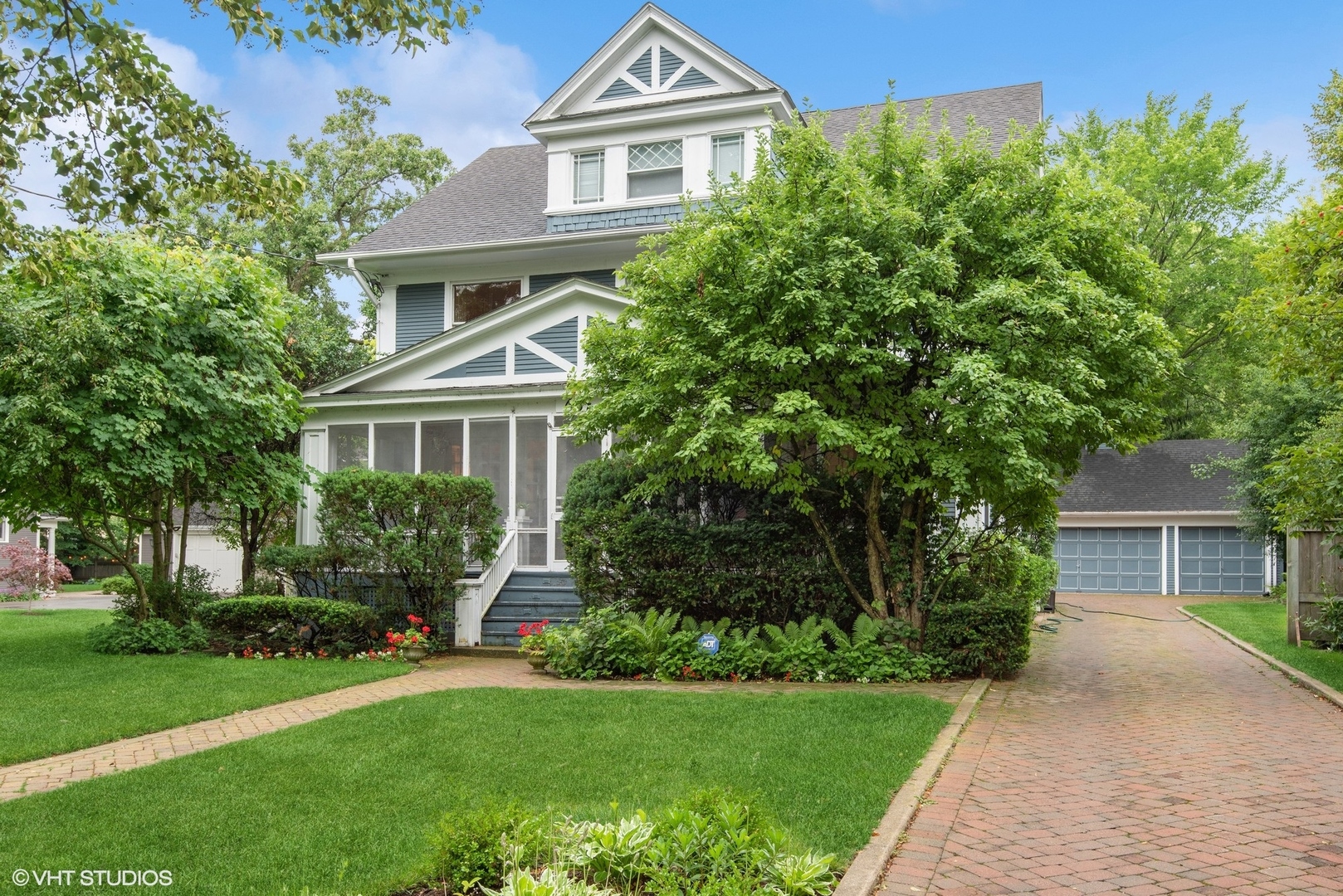 664 Lincoln Avenue Winnetka, IL 60093 - Photo 2 of 26 a front view of a house with a yard and trees