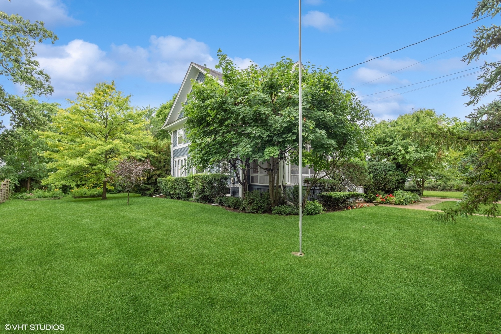 664 Lincoln Avenue Winnetka, IL 60093 - Photo 3 of 26 a view of a field of grass and trees