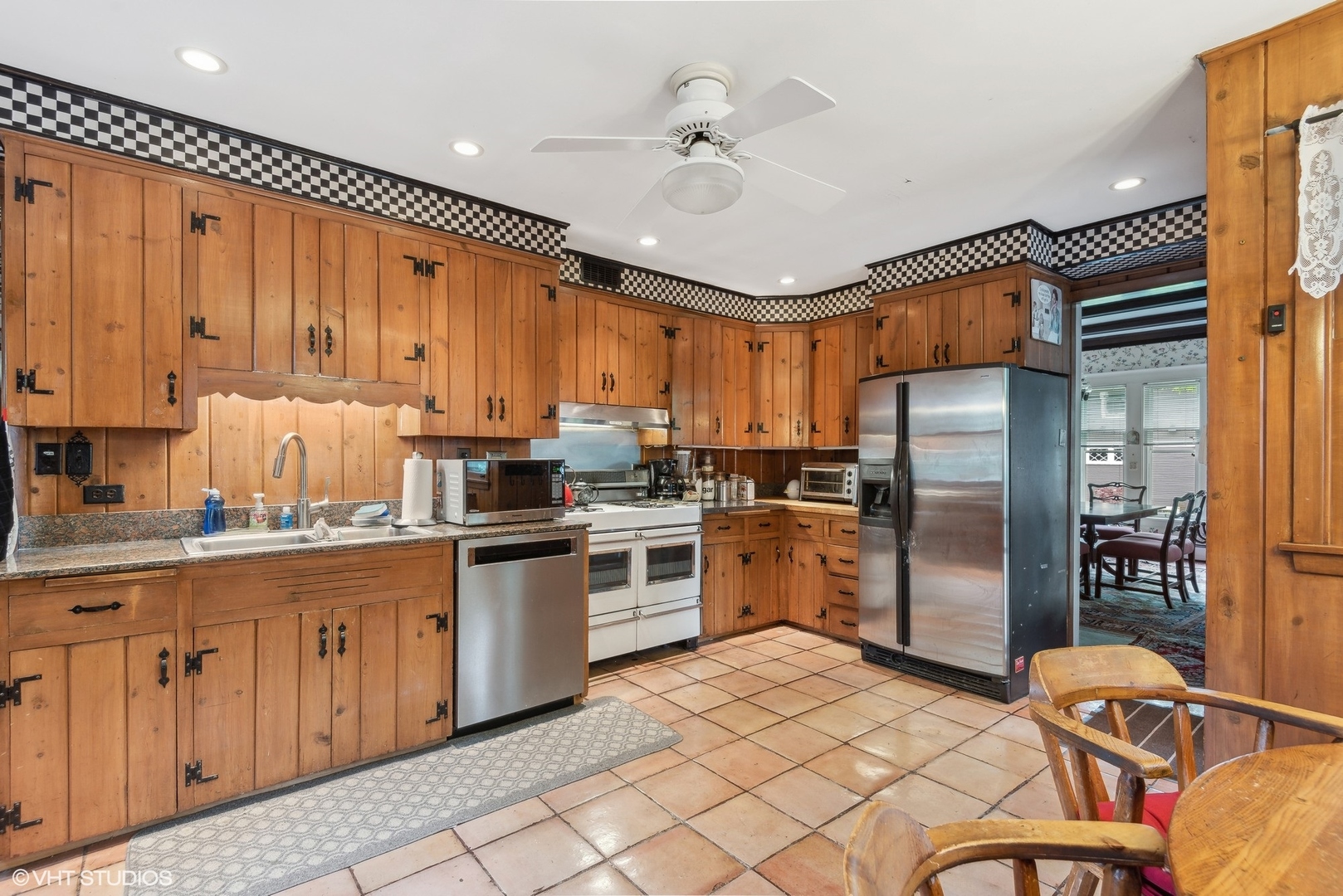 664 Lincoln Avenue Winnetka, IL 60093 - Photo 10 of 26 a kitchen with stainless steel appliances granite countertop a refrigerator a sink dishwasher a stove and white cabinets with wooden floor