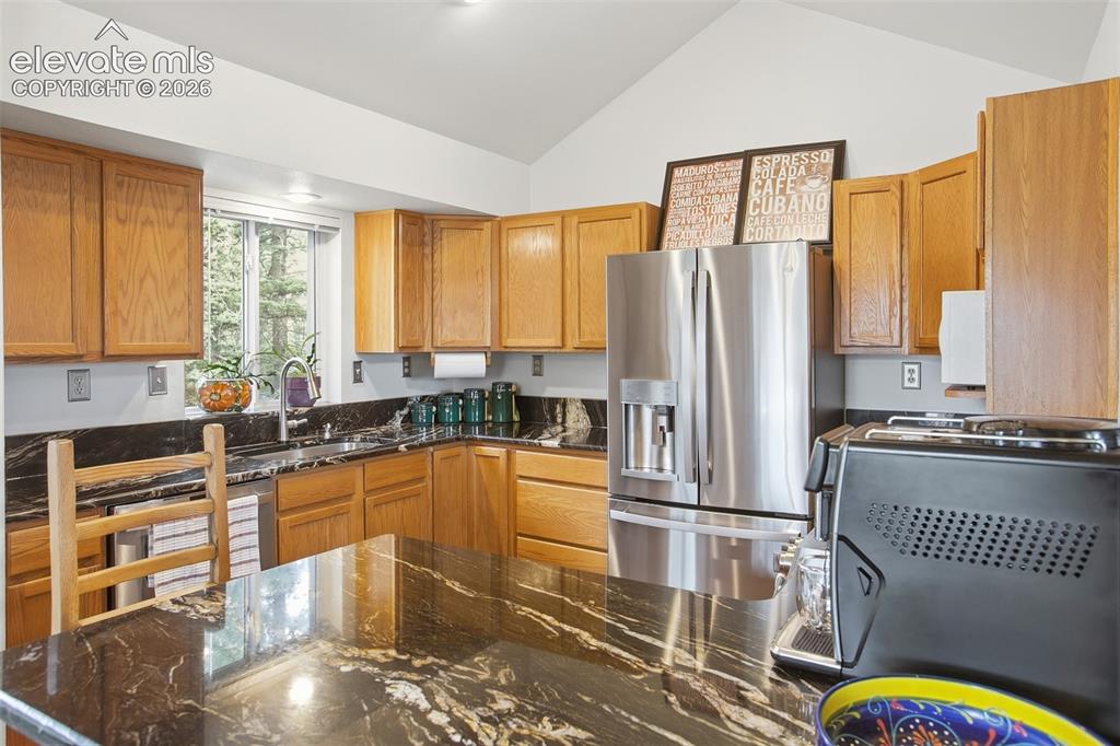 877 North Mountain Estates Road Florissant, CO 80816 - Photo 8 of 23 a kitchen with stainless steel appliances granite countertop a refrigerator and a stove top oven