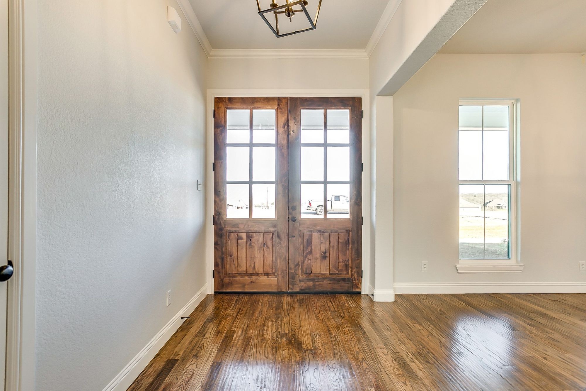 1526 Columbia Road Charlotte, TN 37036 - Photo 2 of 17 an empty room with wooden floor and windows