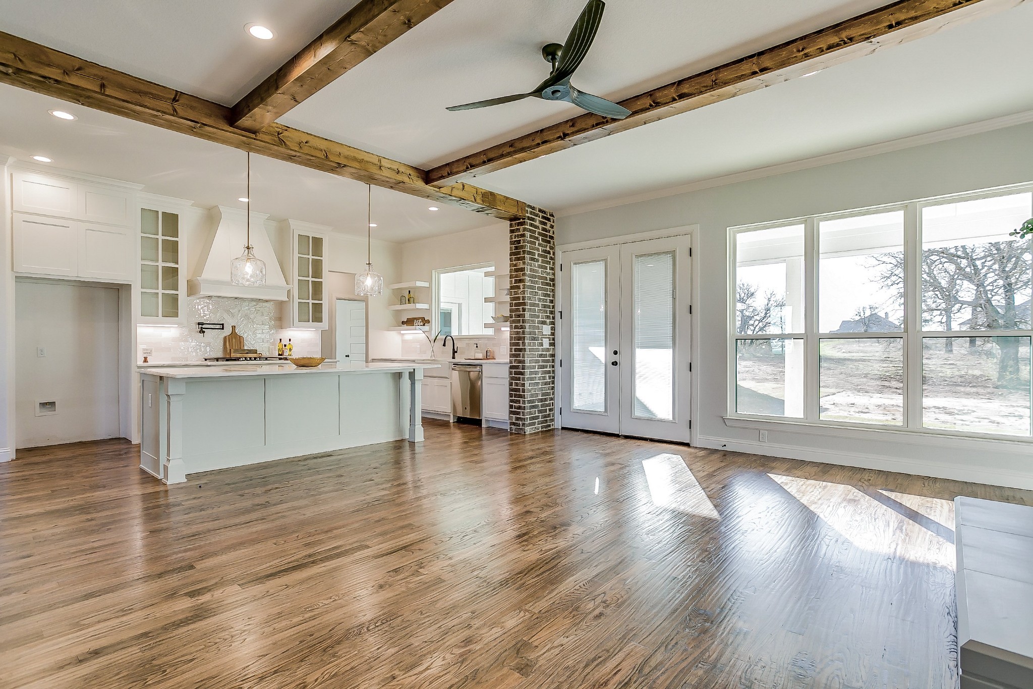 1526 Columbia Road Charlotte, TN 37036 - Photo 4 of 17 a view of an empty room with wooden floor and a kitchen